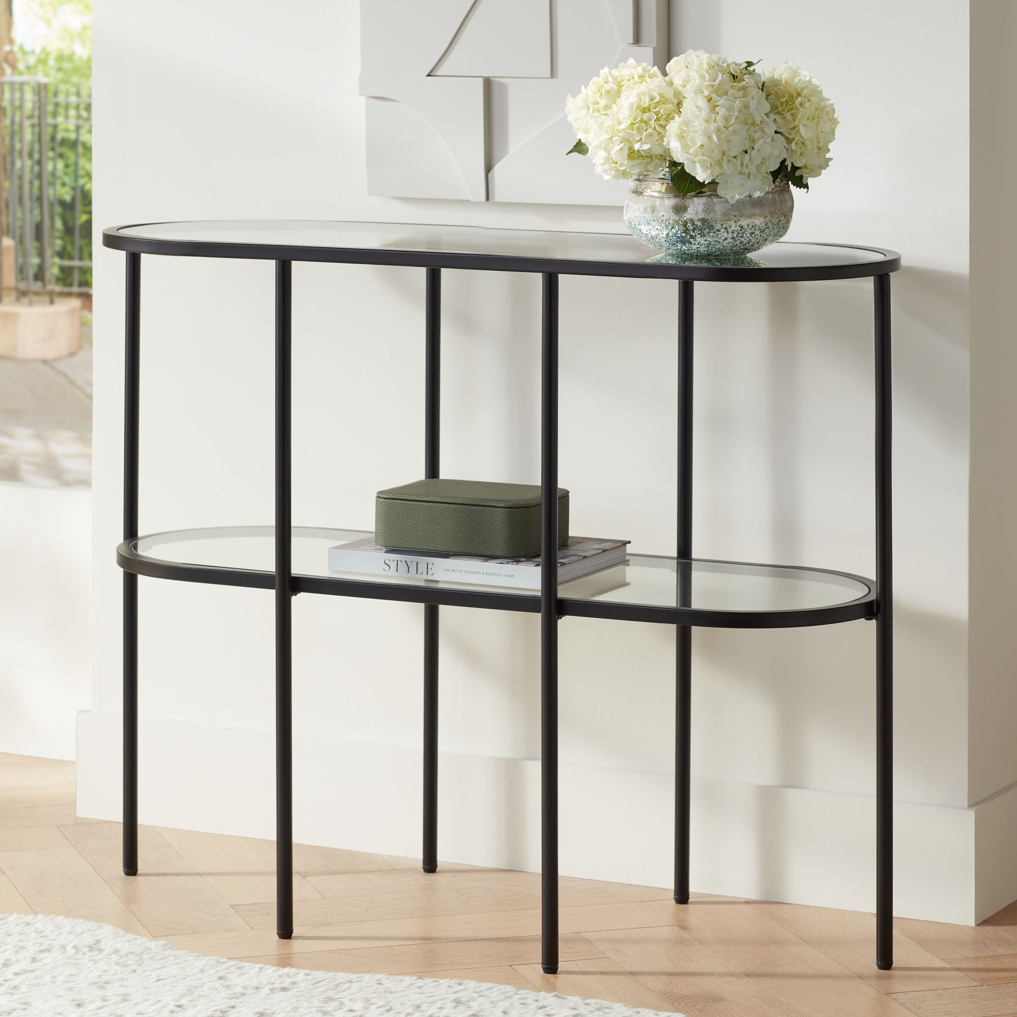 Remy Black Metal Oval Console Table with Clear Glass Shelves and Storage