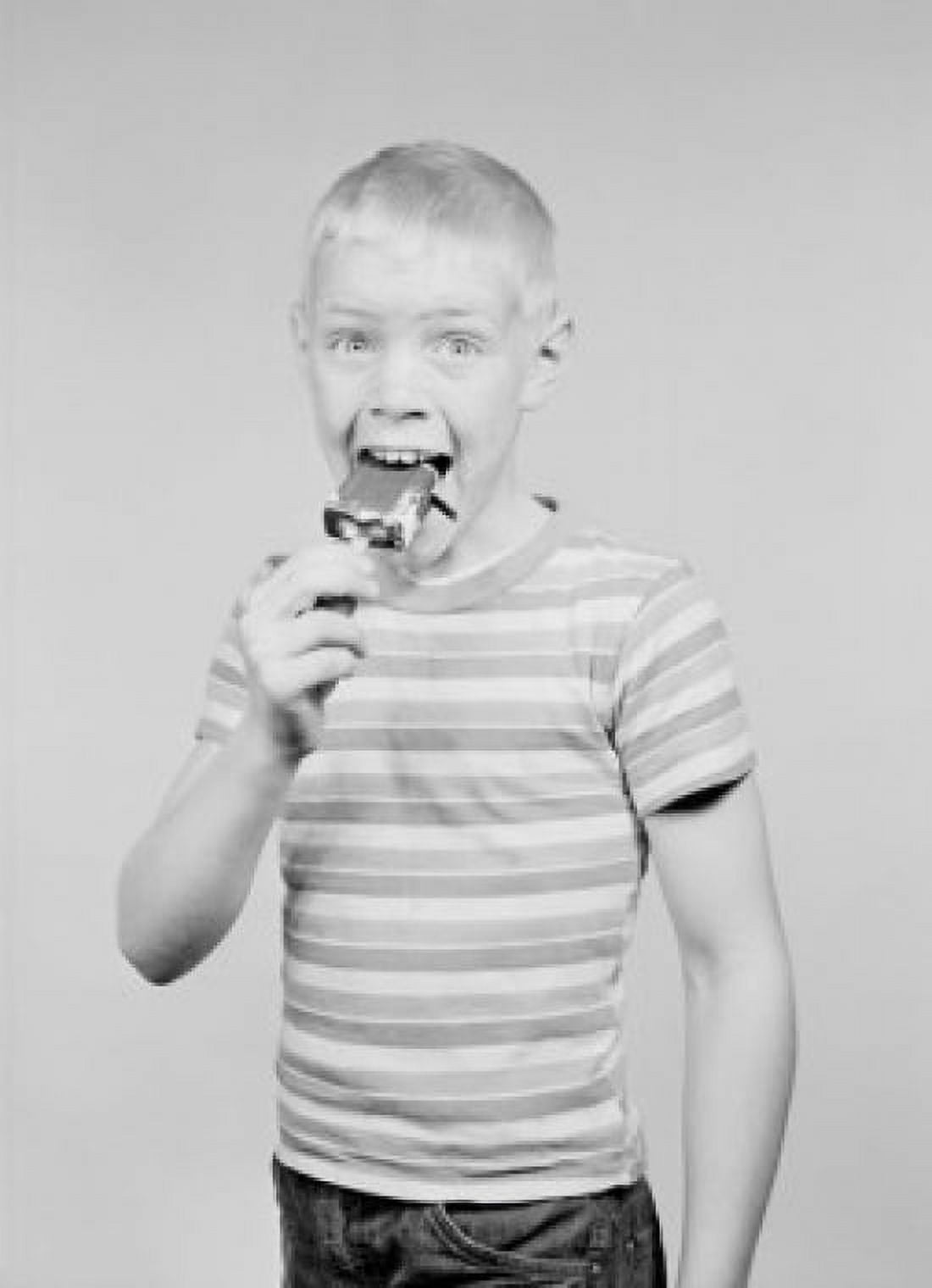 Studio portrait of boy eating ice cream Canvas Art - (18 x 24)