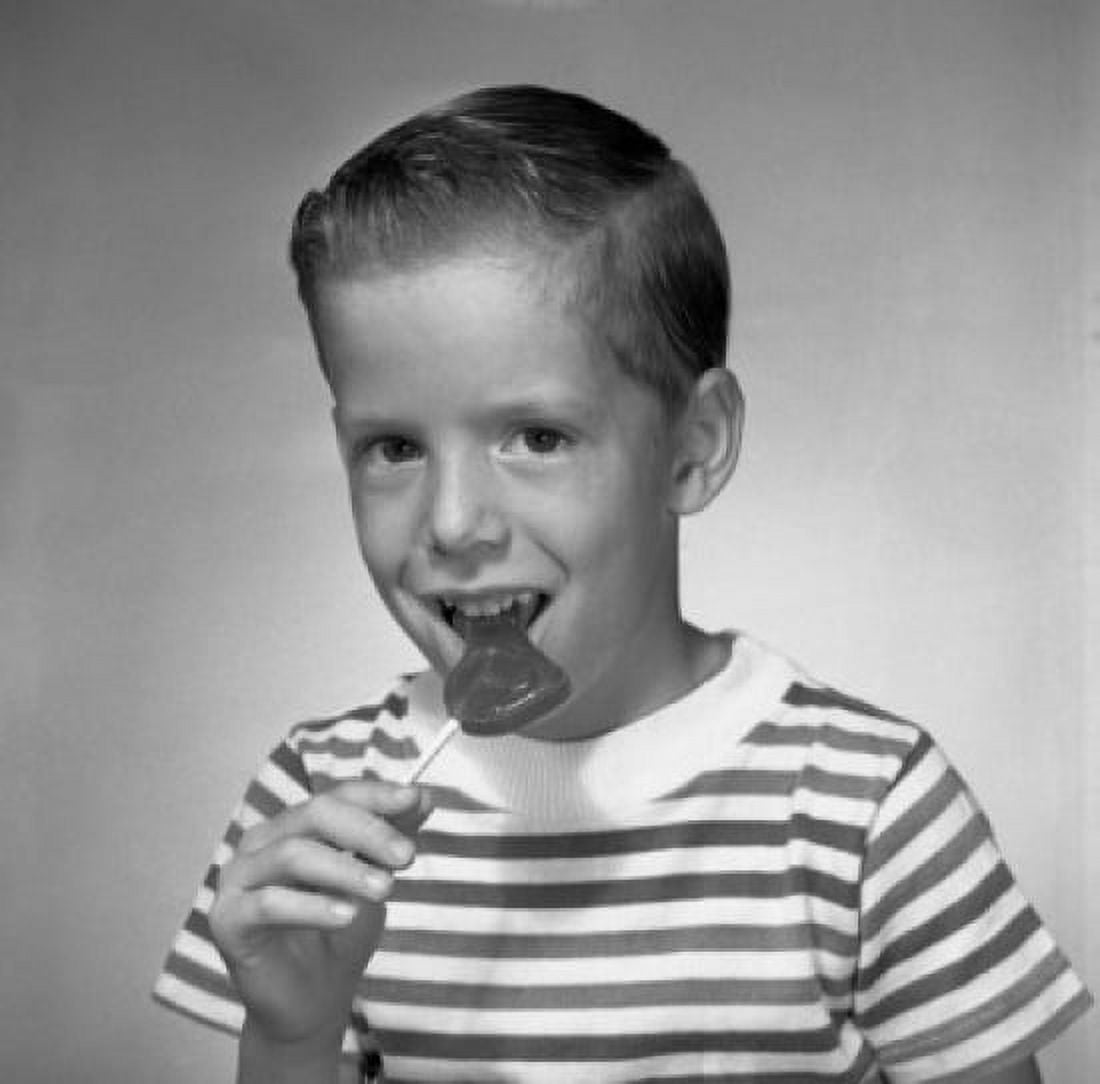 Studio portrait of boy eating lollipop Canvas Art - (18 x 24)