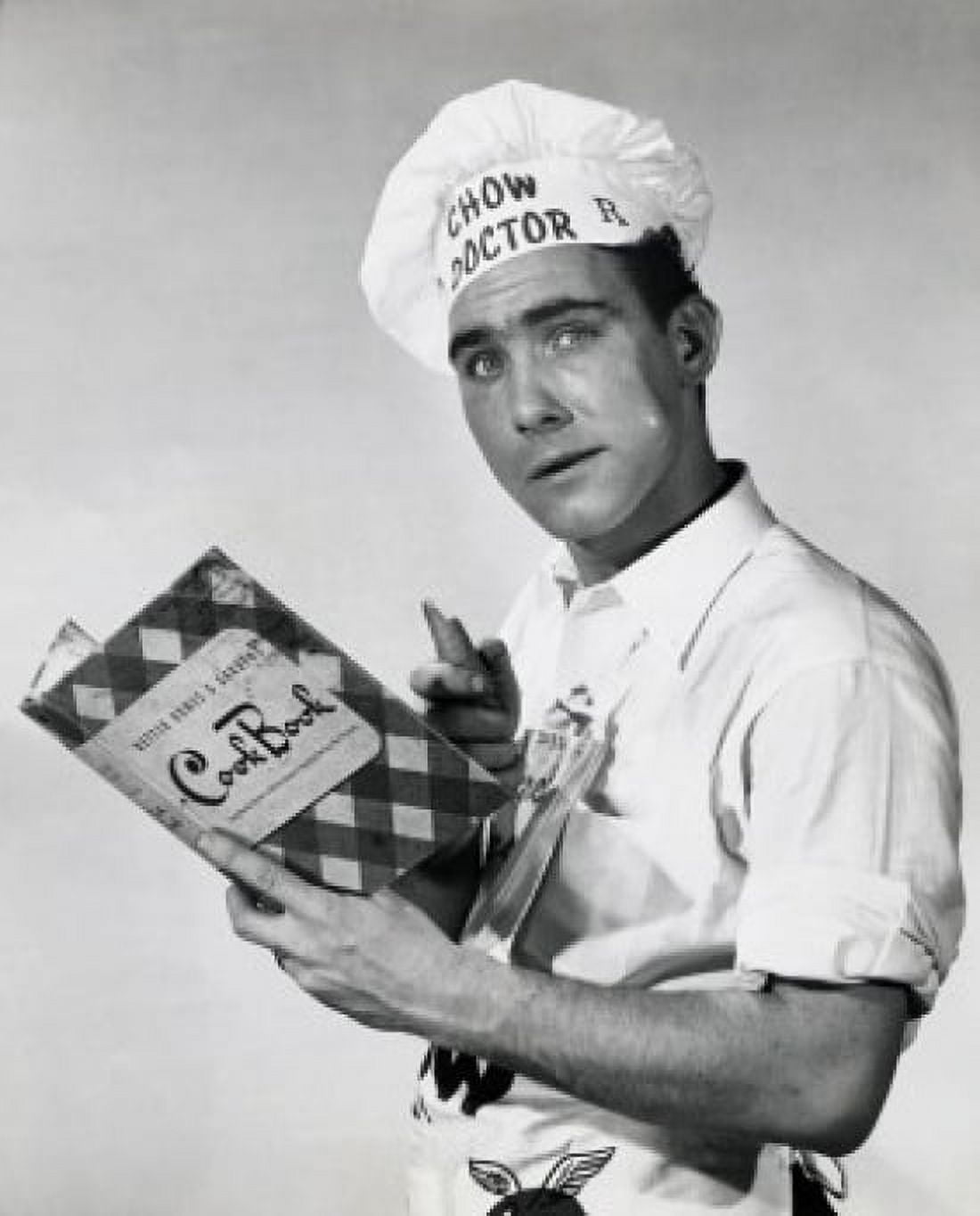 Studio portrait of chef holding cookbook Canvas Art - (24 x 36)