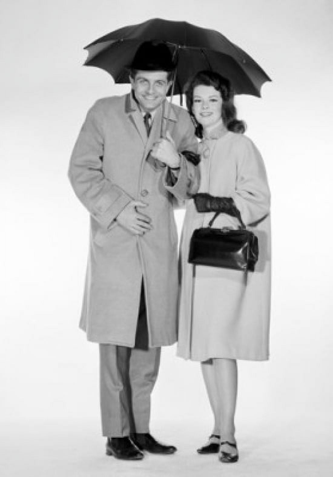 Studio portrait of couple under umbrella Canvas Art - (18 x 24)