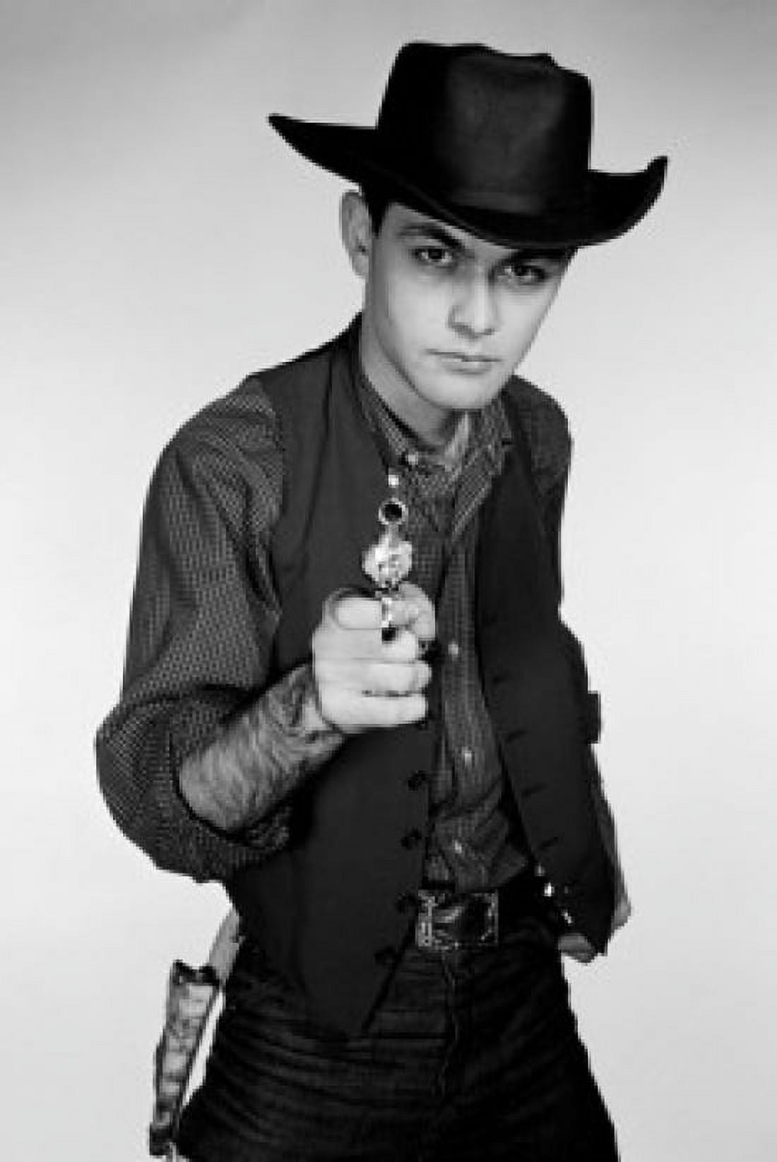 Studio portrait of cowboy aiming gun at camera Canvas Art - (24 x 36)
