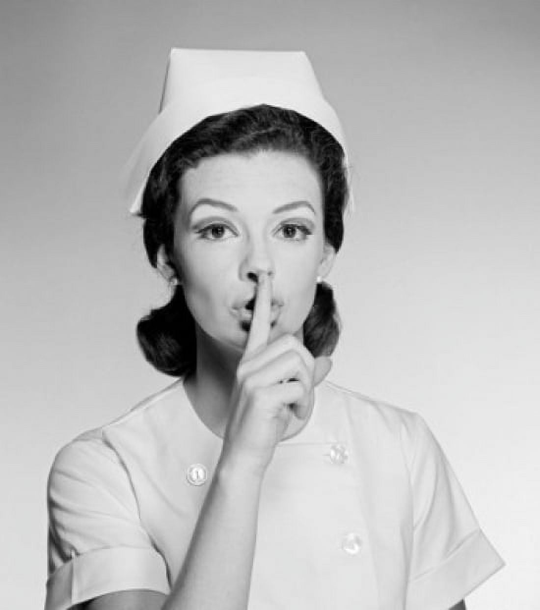 Studio portrait of female nurse gesturing silence Canvas Art - (24 x 36)