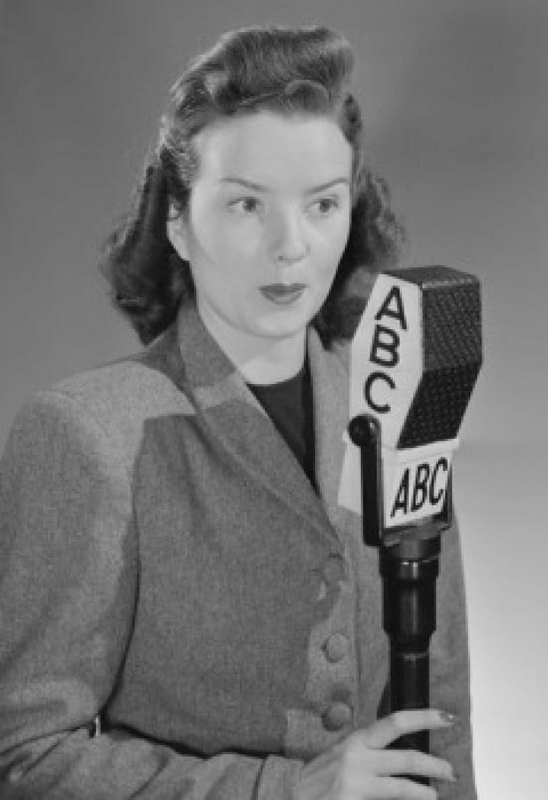 Studio portrait of female reporter speaking into microphone Canvas Art - (18 x 24)