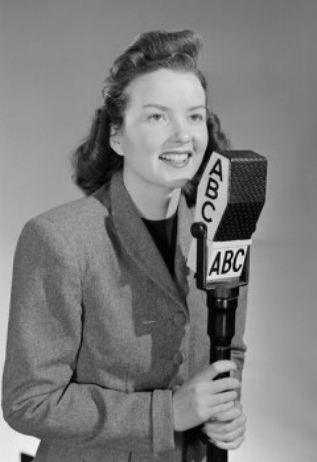 Studio portrait of female reporter speaking into microphone Canvas Art - (18 x 24)