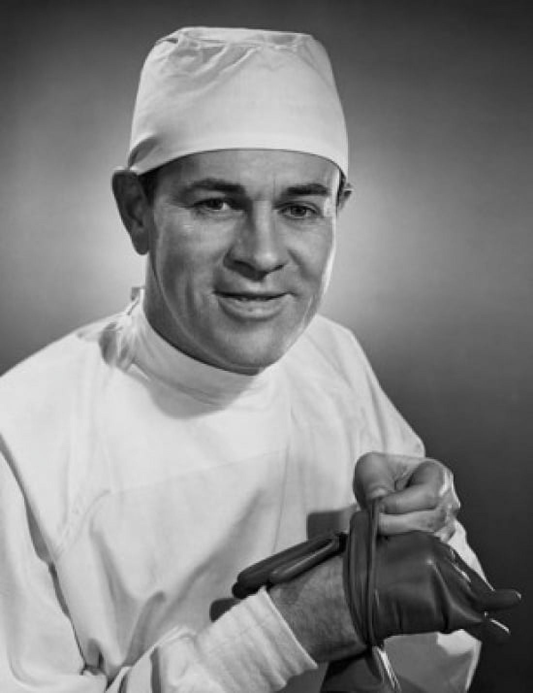 Studio portrait of male surgeon removing gloves Canvas Art - (24 x 36)