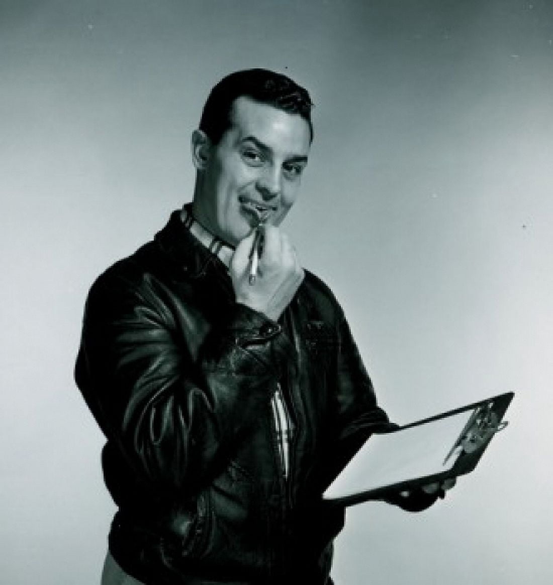 Studio portrait of man holding clipboard and pen Canvas Art - (18 x 24)