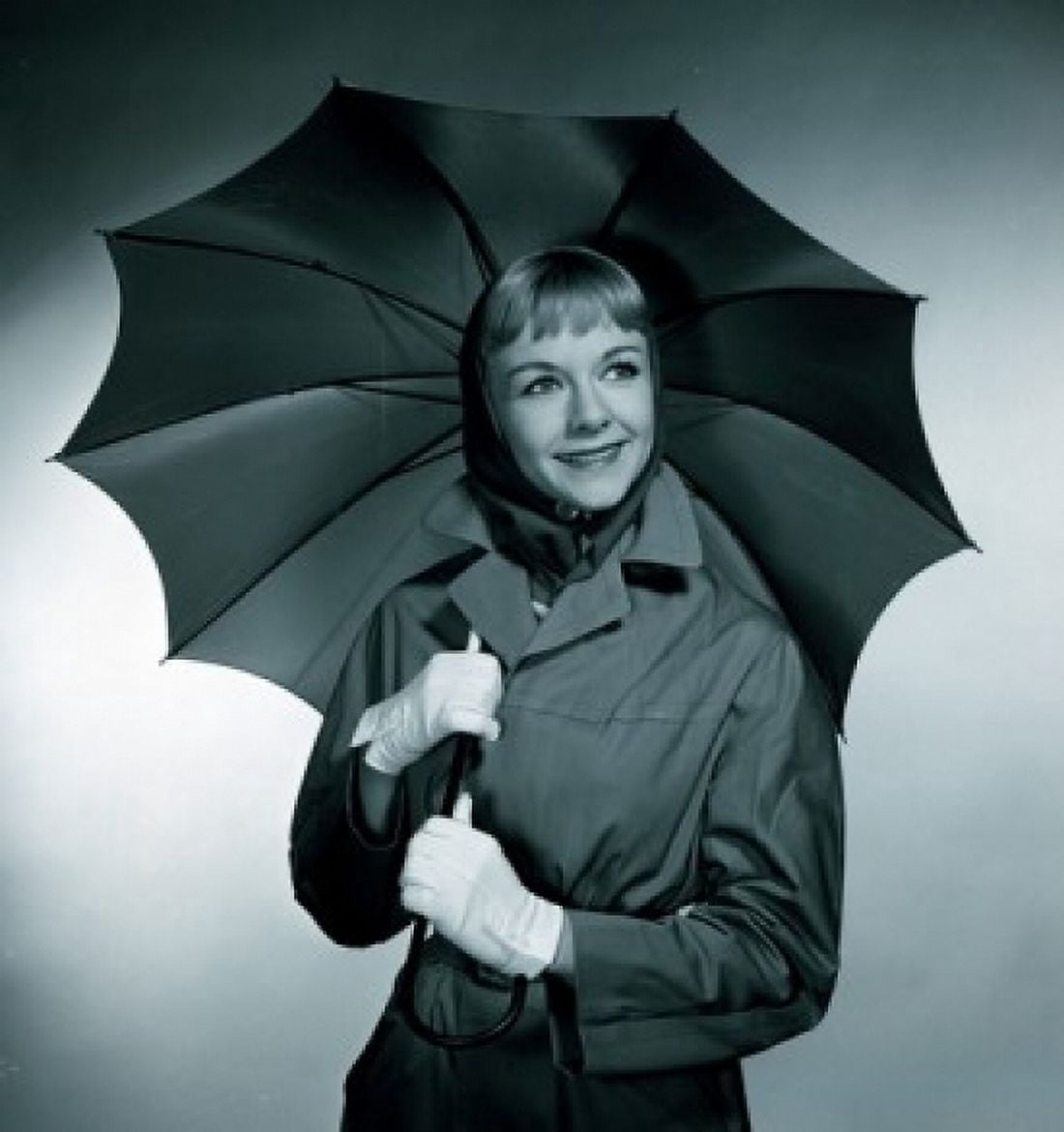 Studio portrait of smiling woman with umbrella Canvas Art - (18 x 24)