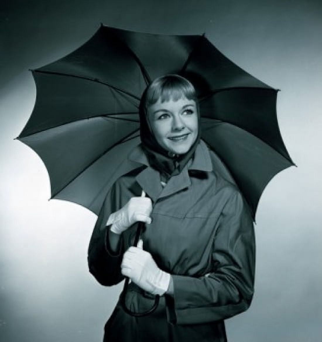 Studio portrait of smiling woman with umbrella Canvas Art - (24 x 36)