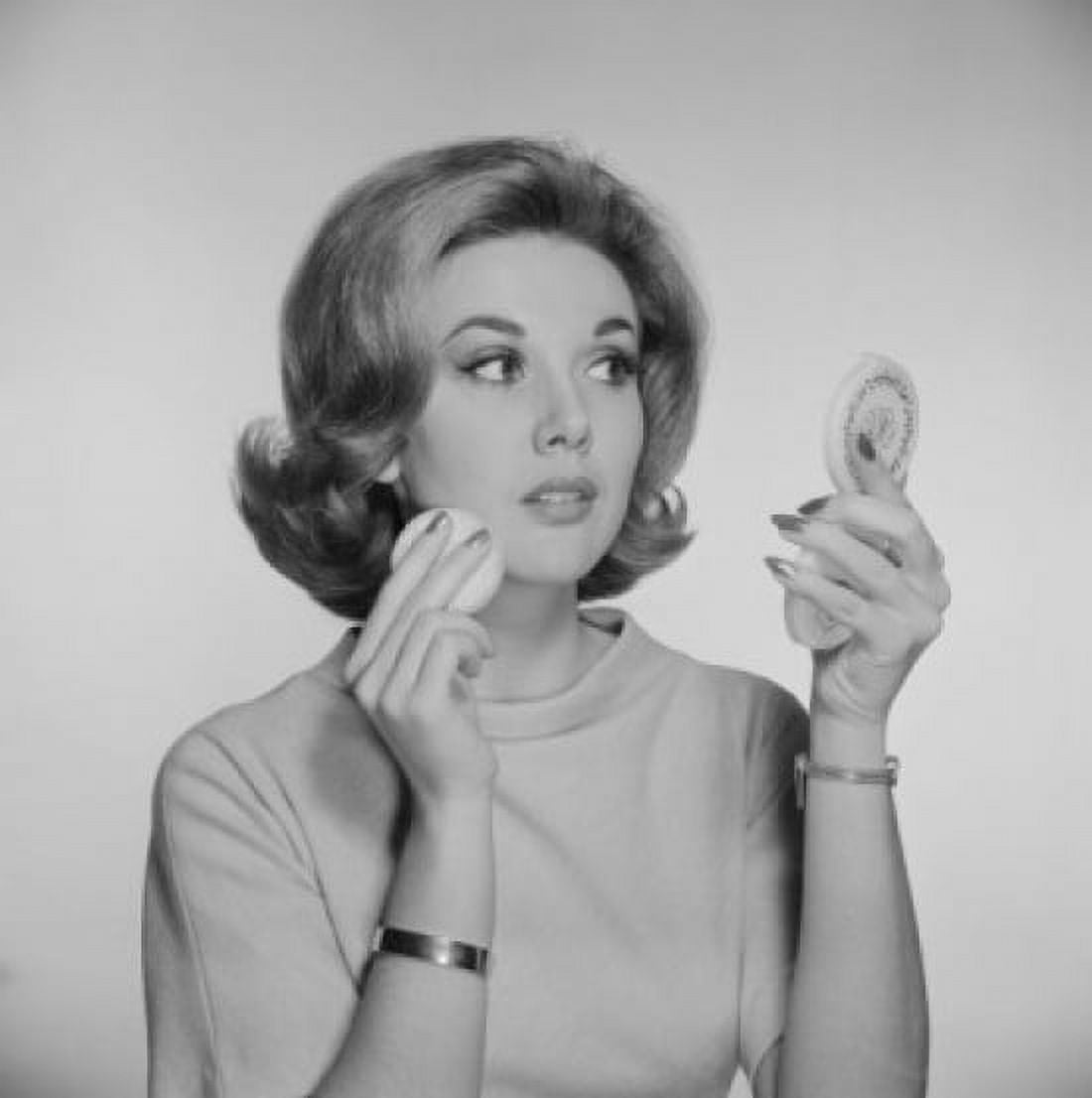 Studio portrait of woman applying make-up Canvas Art - (24 x 36)