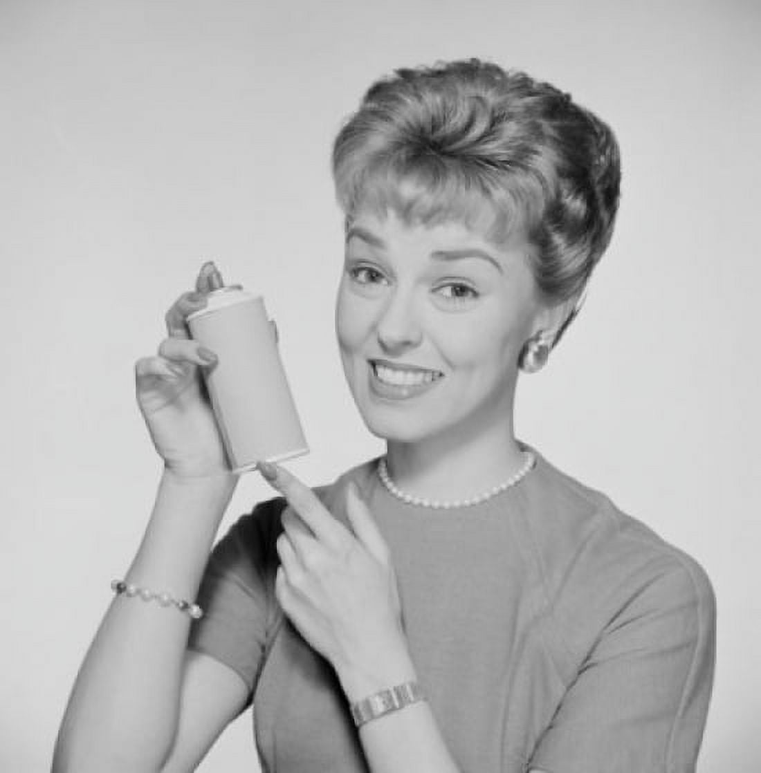 Studio portrait of woman holding spray bottle Canvas Art - (24 x 36)