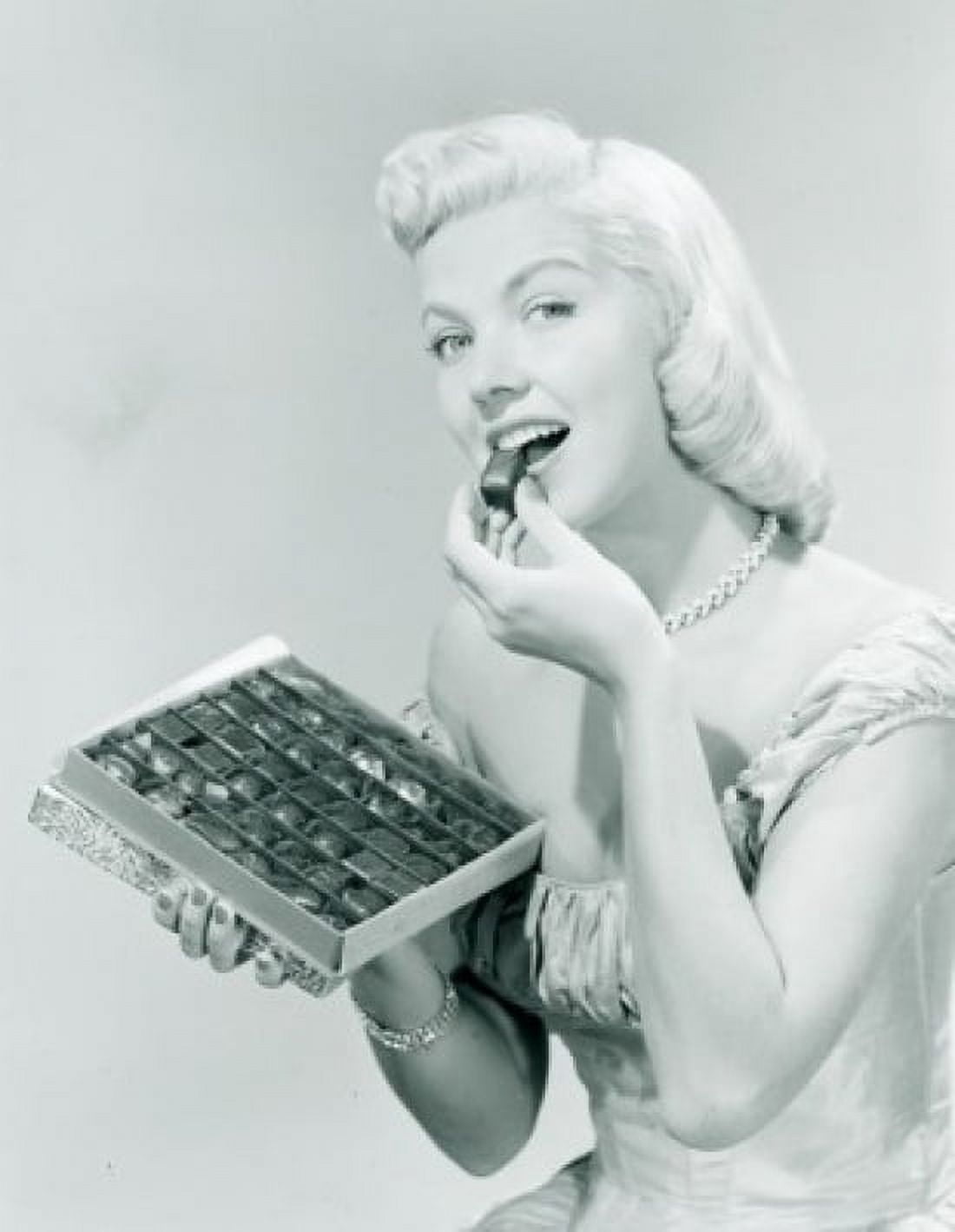 Studio portrait of young woman eating chocolates from box Canvas Art -  (18 x 24)