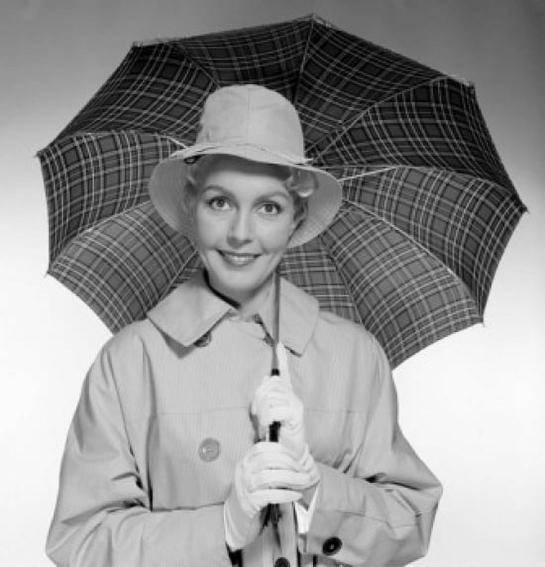 Studio portrait of young woman holding umbrella Canvas Art - (18 x 24)