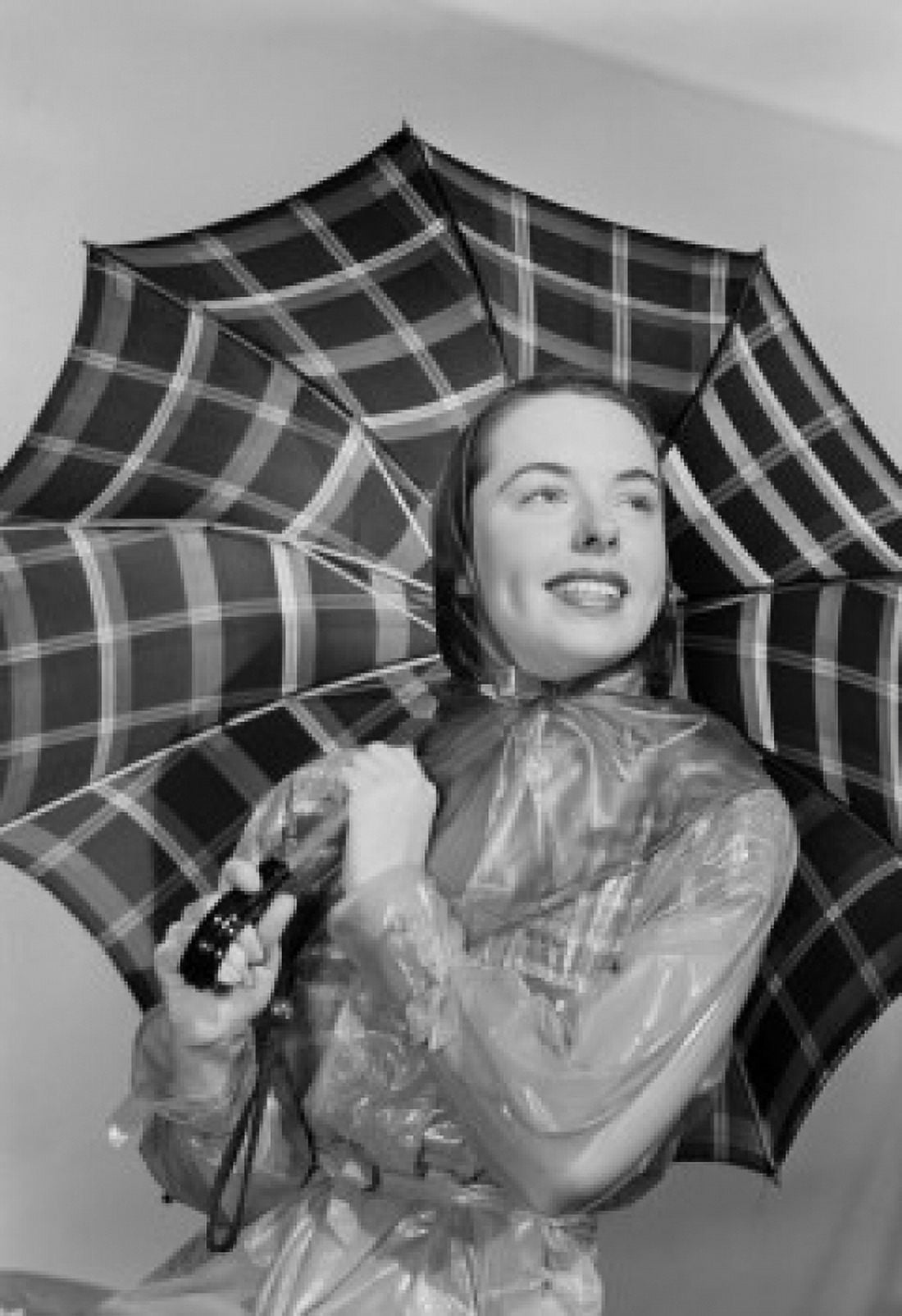 Studio portrait of young woman holding umbrella Canvas Art - (24 x 36)