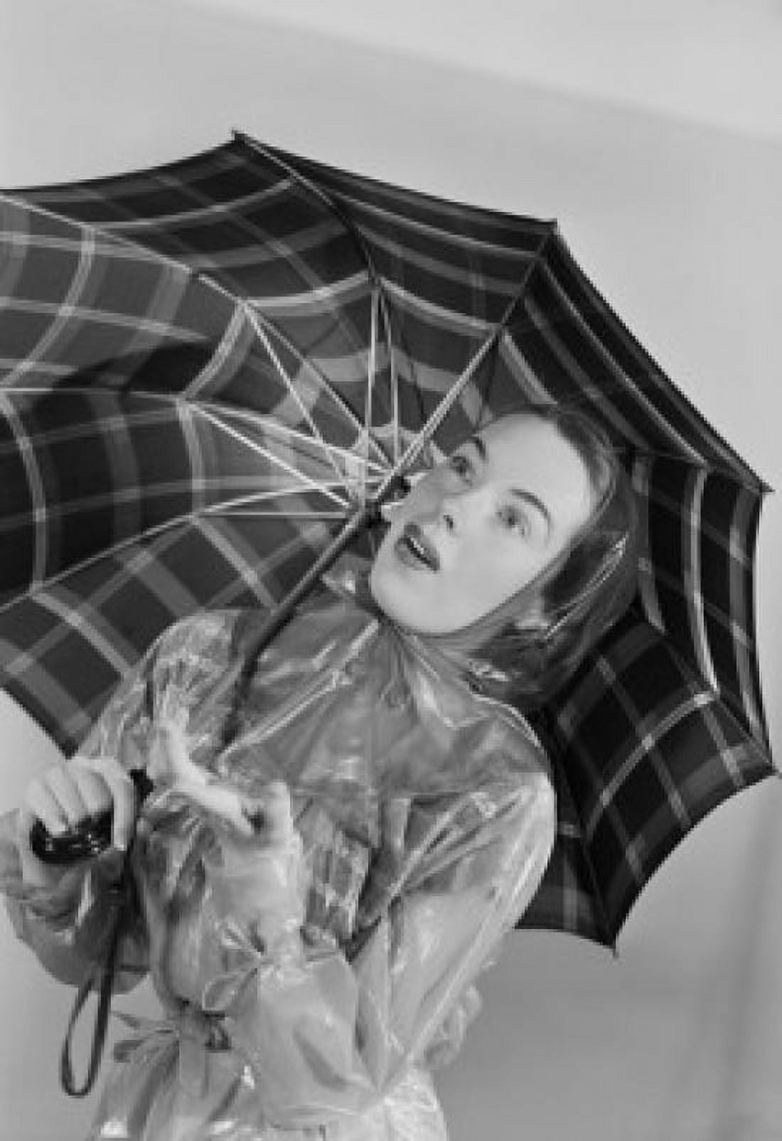 Studio portrait of young woman holding umbrella Canvas Art - (24 x 36)