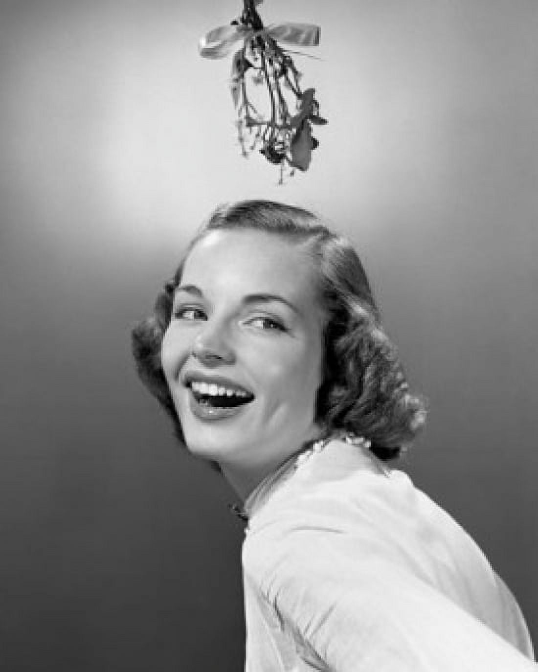 Studio portrait of young woman smiling with mistletoe hanging over her head Canvas Art - (18 x 24)