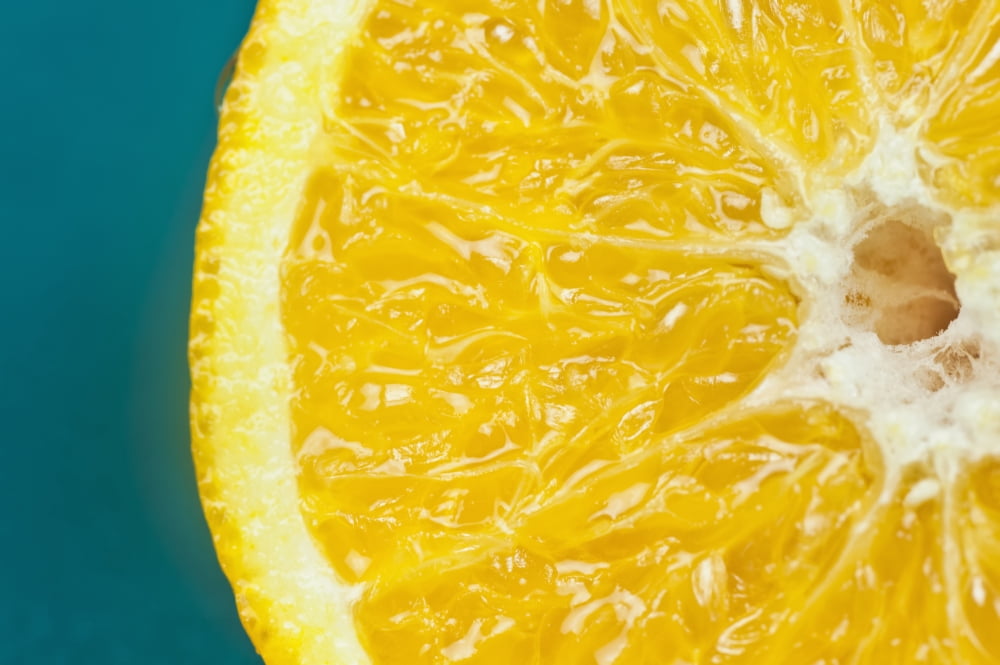 Studio shot of an orange half on a blue background Canvas Art - Bill Brennan Design Pics (18 x 12)