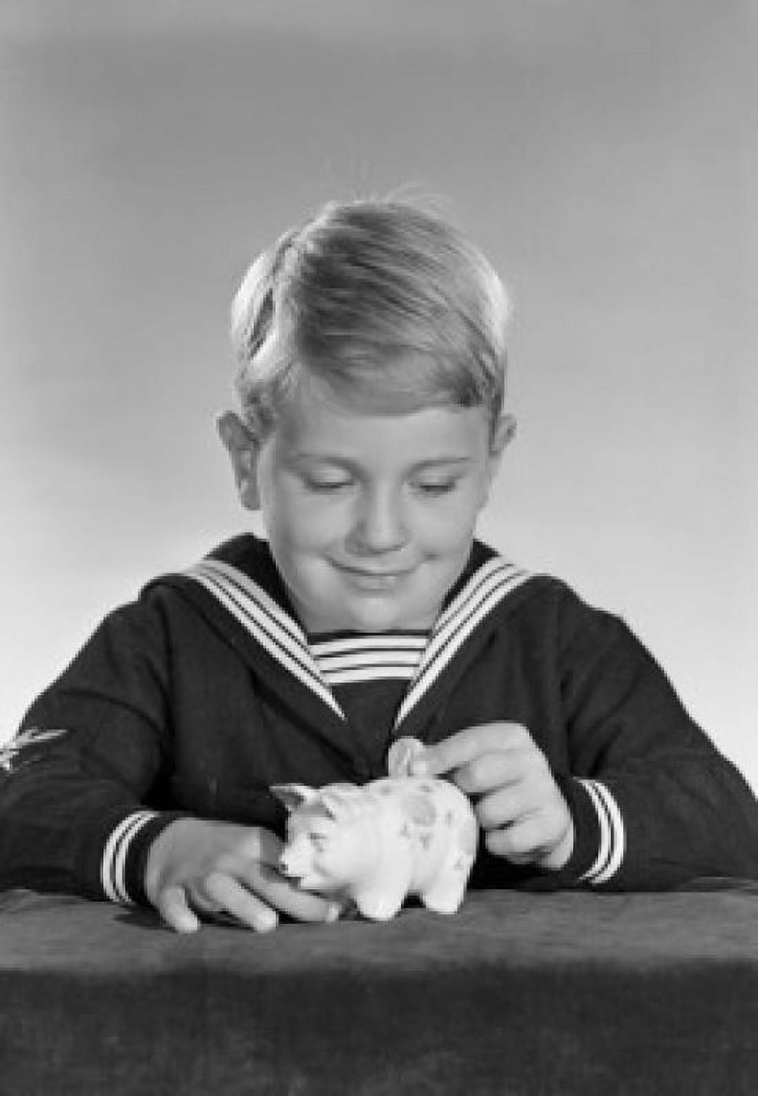 Studio shot of boy inserting coin into piggy bank Canvas Art - (18 x 24)