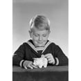 thumbnail image 1 of Studio shot of boy inserting coin into piggy bank Poster Print (18 x 24), 1 of 4