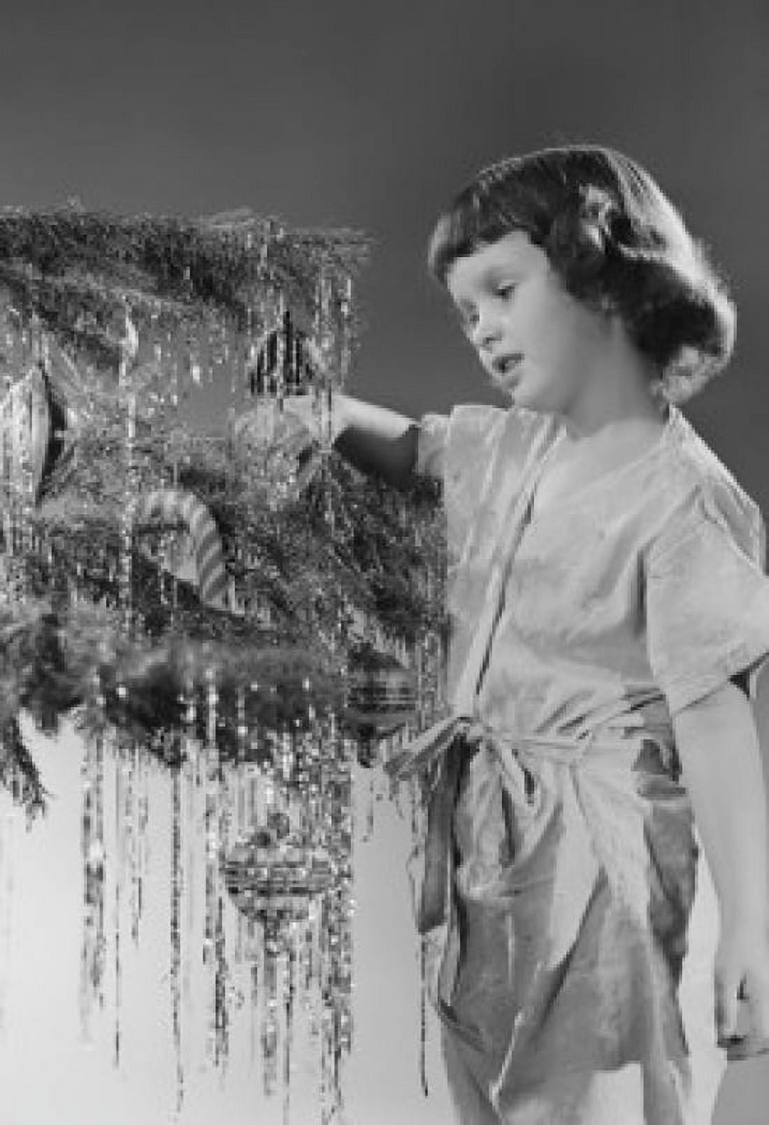 Studio shot of girl decorating Christmas tree Canvas Art - (18 x 24)