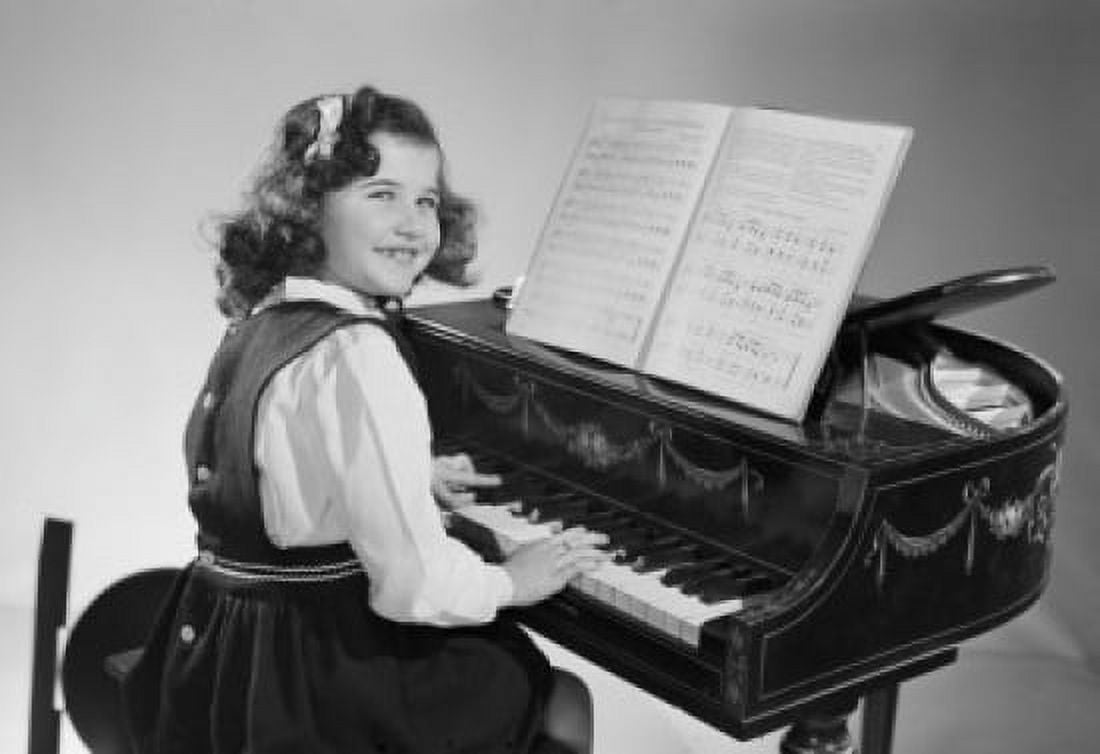 Studio shot of girl playing piano Canvas Art - (24 x 36)
