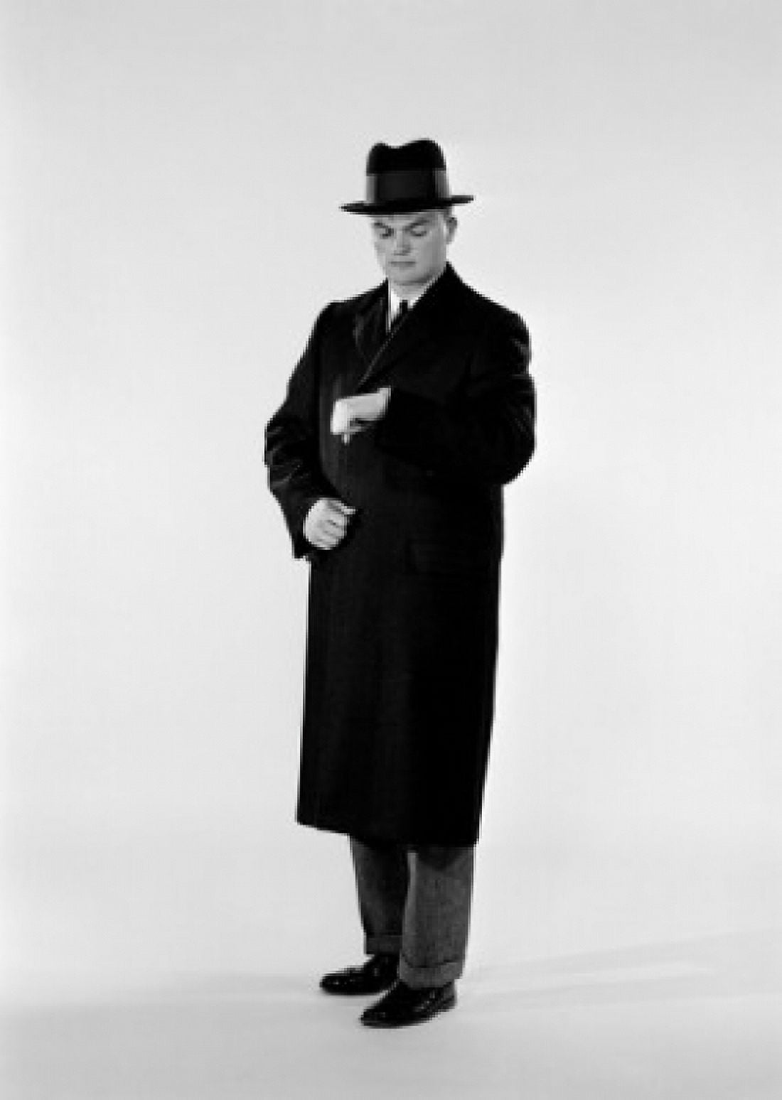 Studio shot of man in coat looking at wristwatch Canvas Art - (18 x 24)