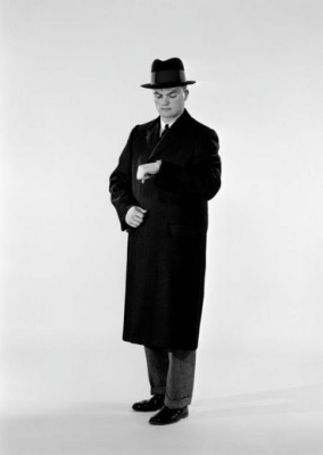 Studio shot of man in coat looking at wristwatch Canvas Art - (24 x 36)