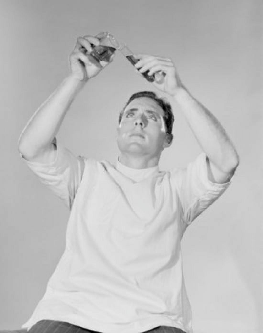 Studio shot of scientist pouring liquid Canvas Art - (18 x 24)