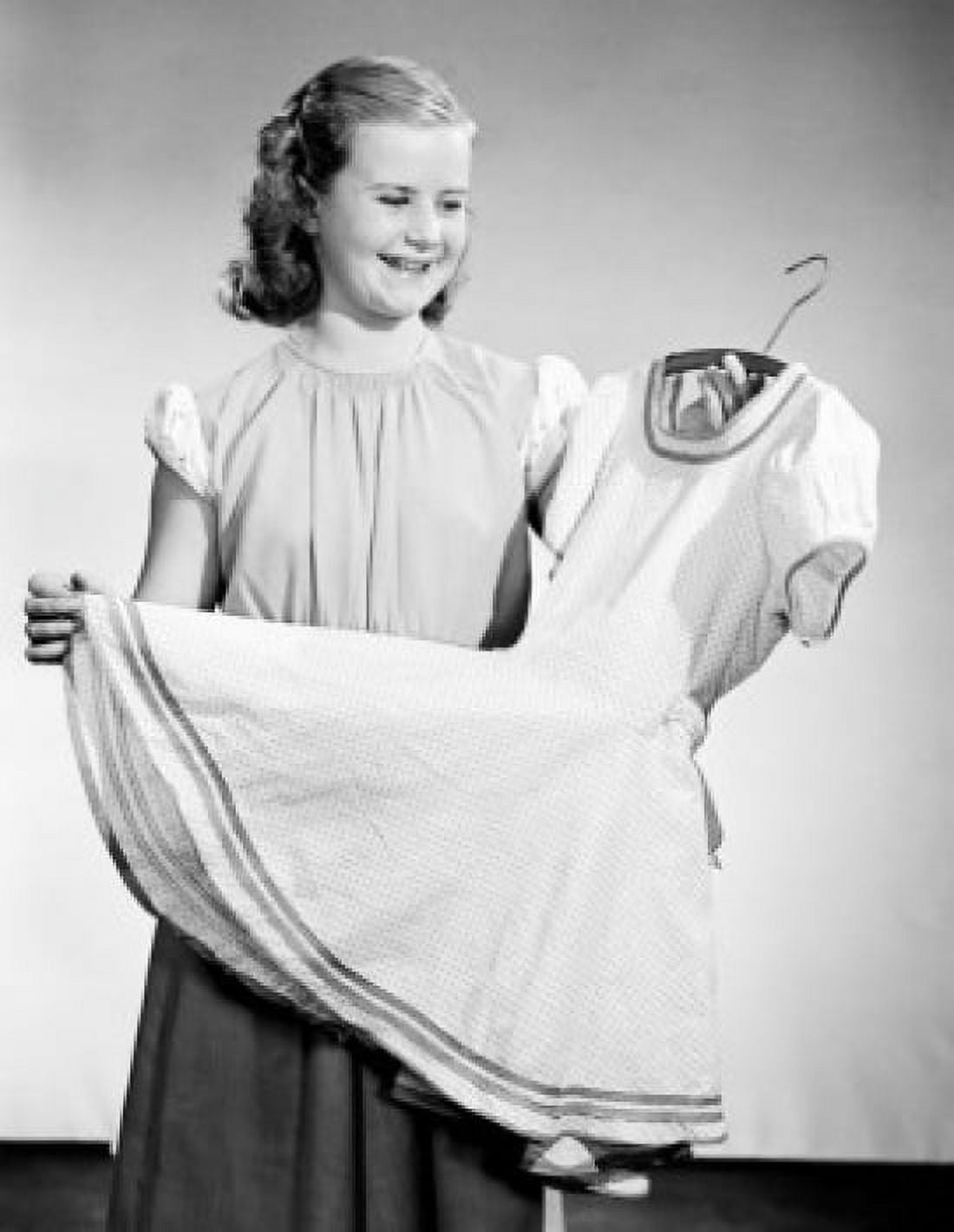 Studio shot of smiling girl holding new dress on hanger Canvas Art - (18 x 24)