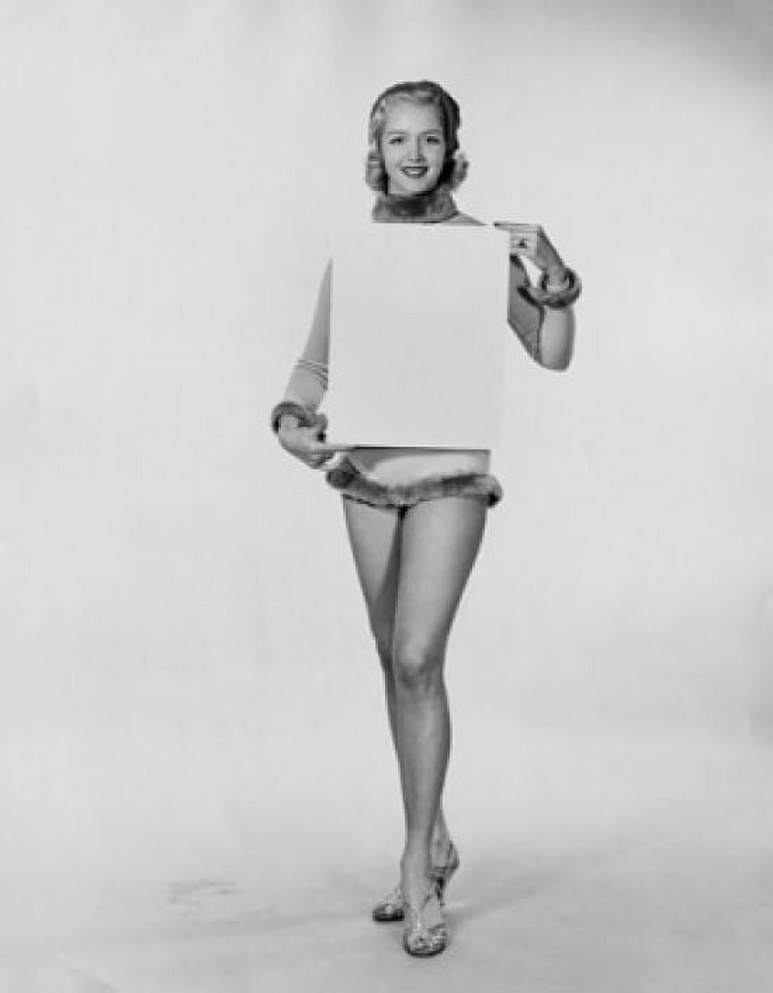 Studio shot of young woman holding blank placard Canvas Art - (18 x 24)