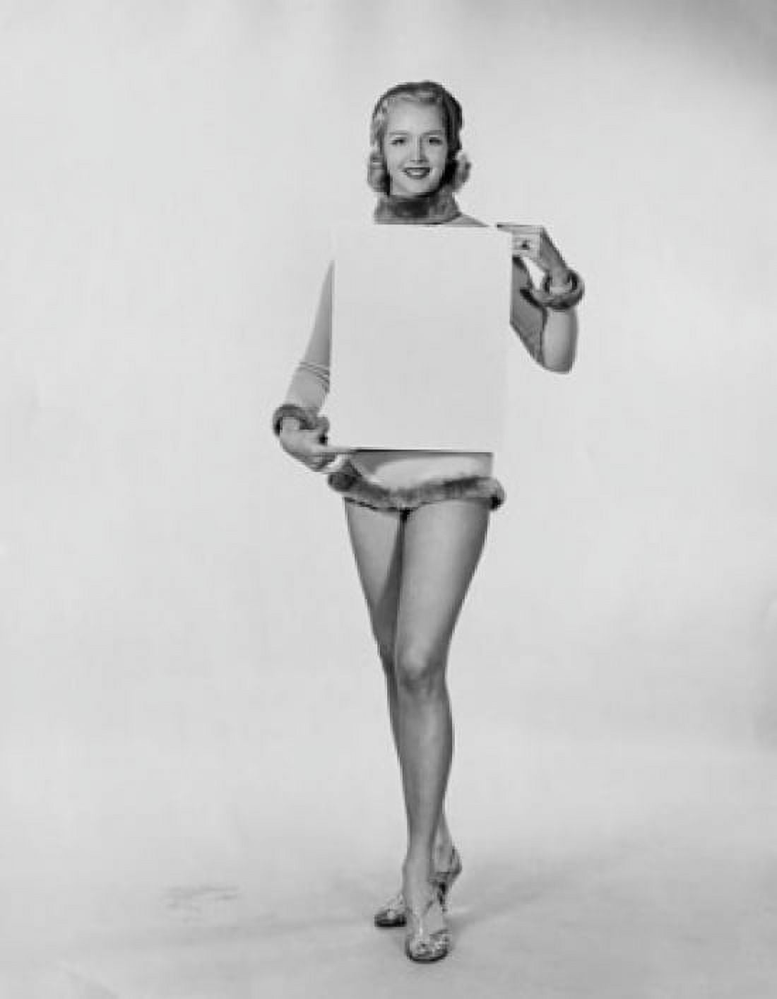 Studio shot of young woman holding blank placard Canvas Art - (24 x 36)
