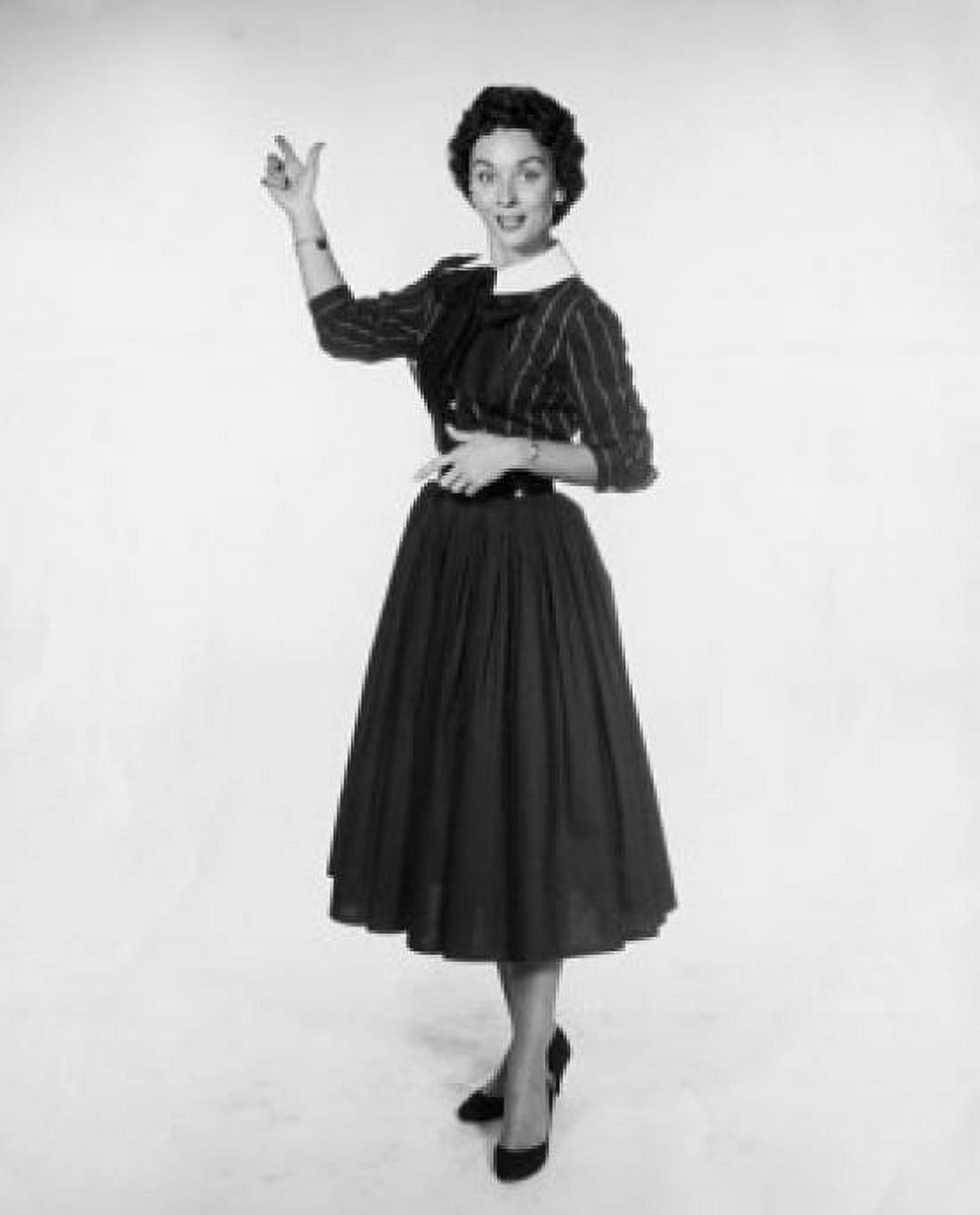 Studio shot of young woman pointing backwards Canvas Art - (24 x 36)