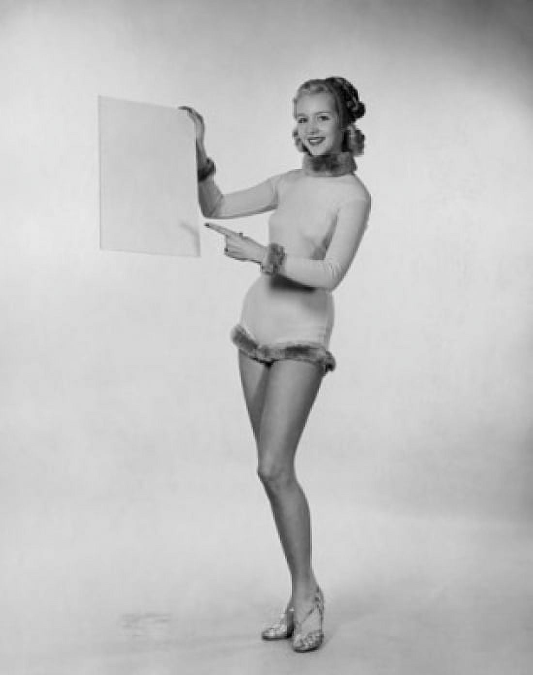 Studio shot of young woman pointing to blank placard Canvas Art - (24 x 36)
