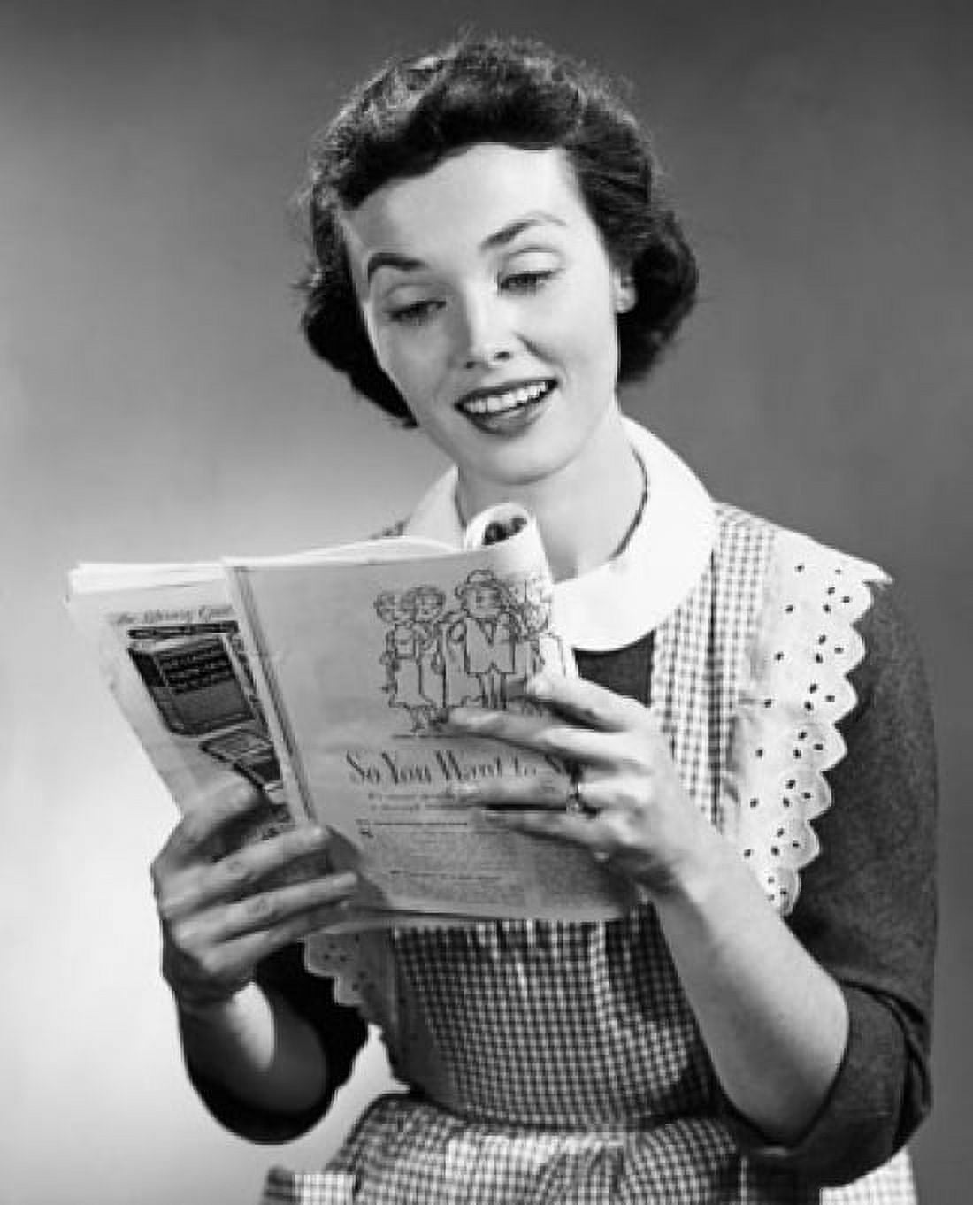 Studio shot of young woman reading magazine Canvas Art - (18 x 24)