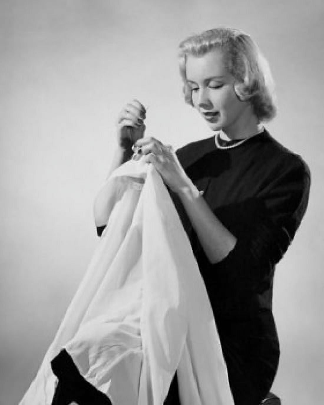 Studio shot of young woman sewing Canvas Art - (18 x 24)