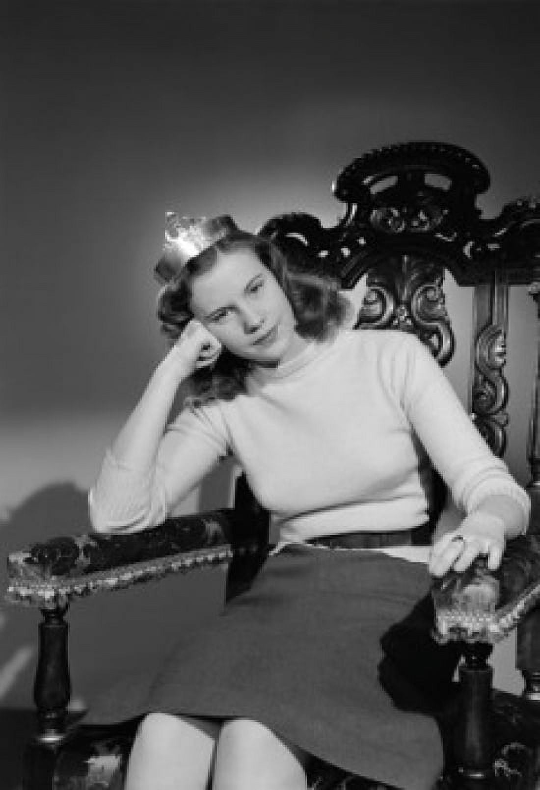 Studio shot of young woman wearing crown sitting in chair Canvas Art - (24 x 36)