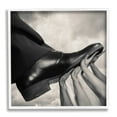 thumbnail image 1 of Stupell Industries Hands Holding Dress Shoe Monochrome Photography Clouds Framed Wall Art, 24 x 24, Design by Tommy Ingberg, 1 of 5