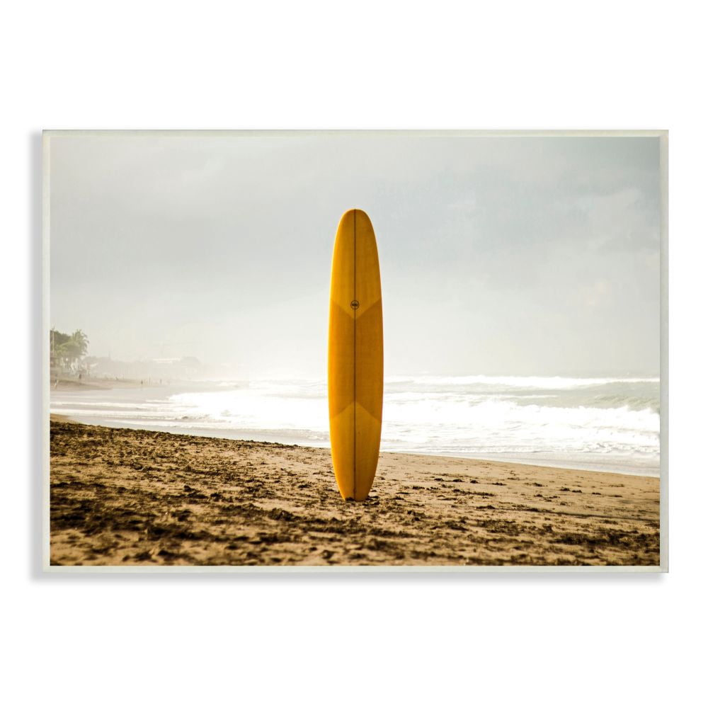 Stupell Industries Yellow Surfboard in Sand Near Shore Photograph Designed by Unsplash