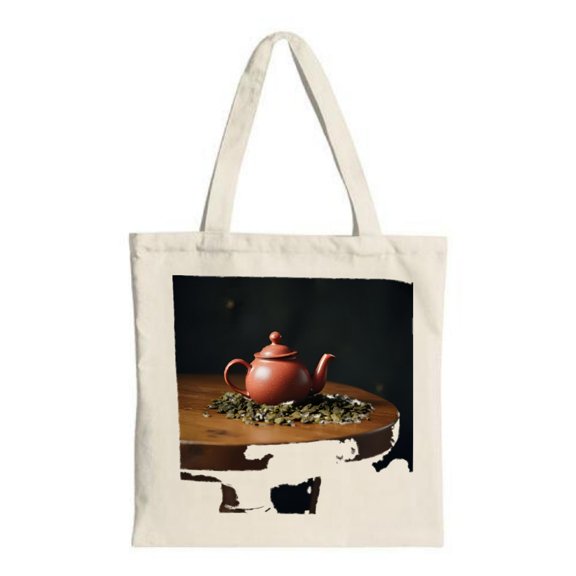 Stylish Canvas Tote Bag featuring a vibrant red teapot on a wooden surface accented by loose tea leaves perfect for shopping and travel