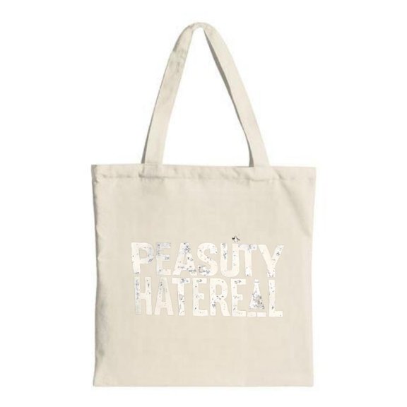 Stylish Canvas Tote Bag with " PEASUY HATERELL " in bold white letters perfect for shopping travel and parties Minimalist design