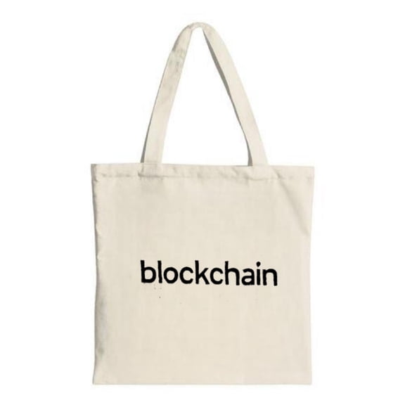 Stylish canvas tote bag with sturdy handles featuring ' blockchain ' in bold black lowercase letters perfect for shopping and travel
