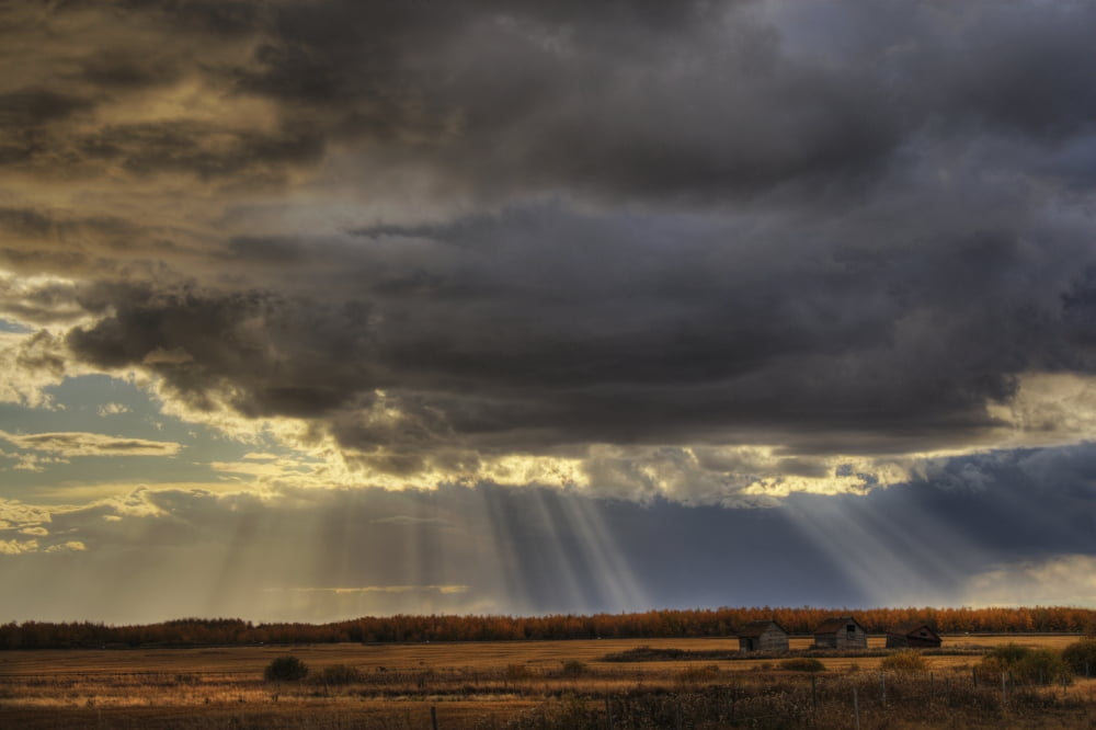 Sun Rays Through Clouds Over Three Old Grain Bins Rural Alberta Canvas Art - Dan Jurak Design Pics (34 x 22)