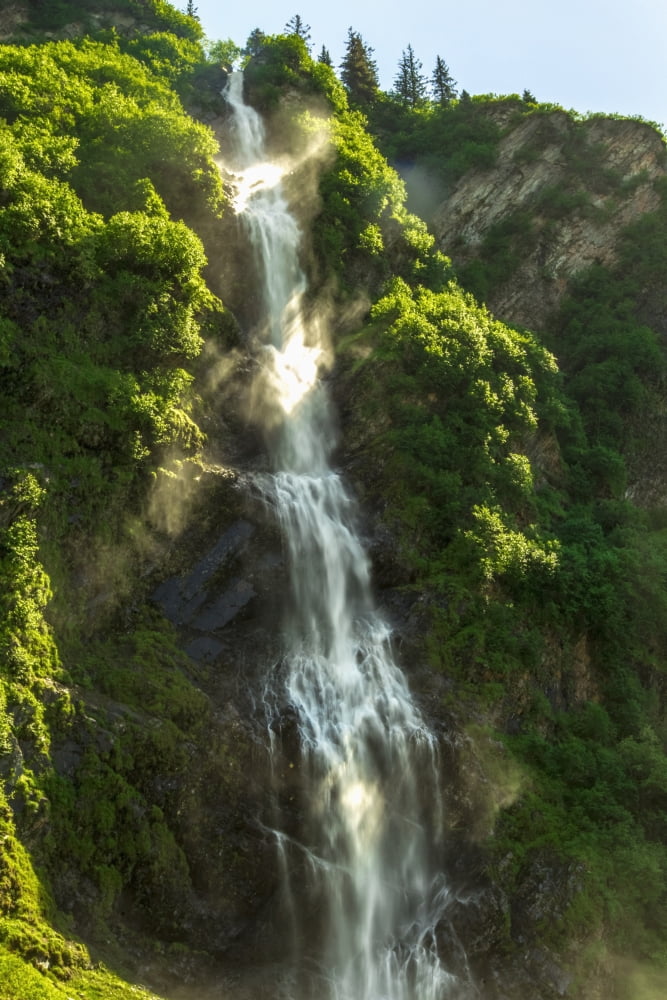 Sun rays flow through the mist of Bridal Veil Falls a popular pull off along the Richardson Highway near Valdez Alaska United States of America Canvas Art - Zachary Sheldon Design Pics (12 x 19)