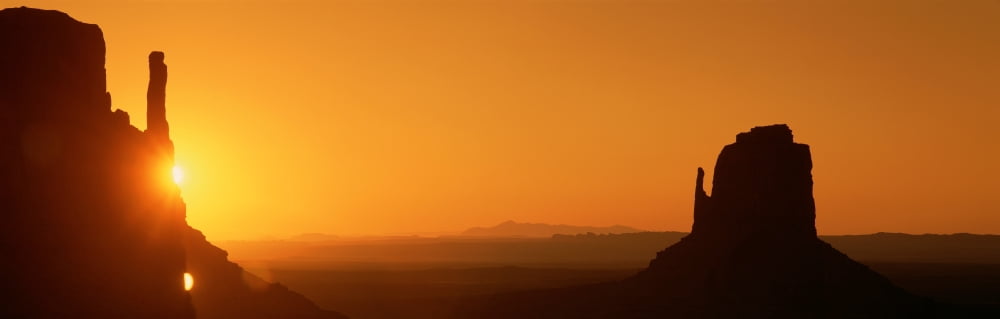 Sun setting at Monument Valley Arizona Canvas Art - Panoramic Images (36 x 12)