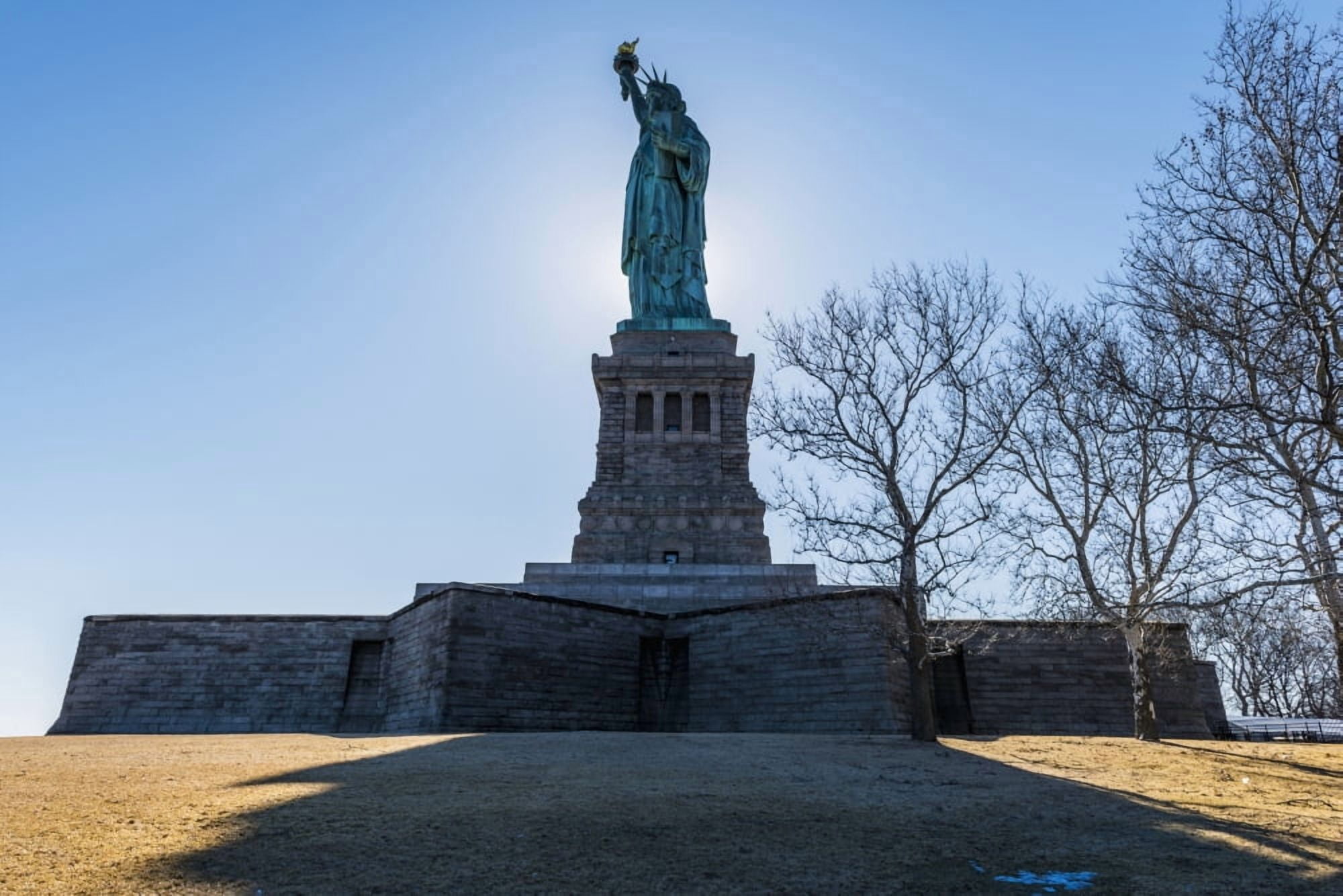 Sun setting behind the Statue of Liberty Liberty Island New York City New York United States of America Canvas Art - F M Kearney Design Pics (38 x 24)