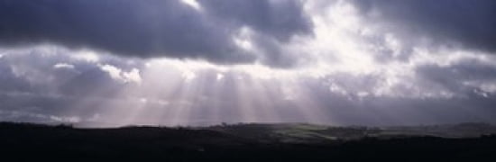 Sunbeams radiating through dark clouds over rolling hills Dartmoor Devon England Canvas Art - Panoramic Images (36 x 12)