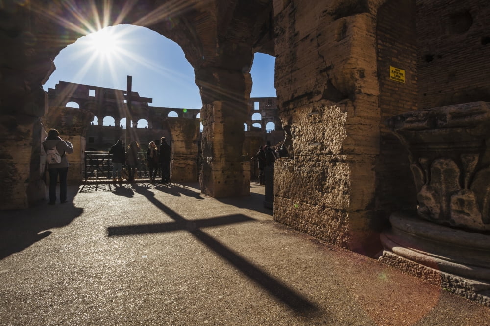 Sunburst through an archway at the Colosseum and a shadow of a cross Rome Italy Canvas Art - Reynold Mainse Design Pics (38 x 24)