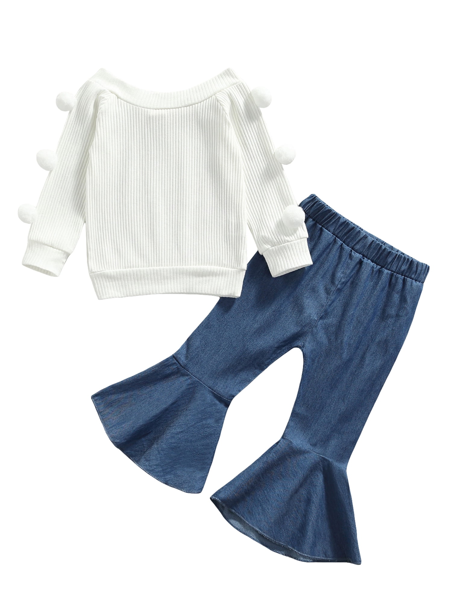 White sweater with shop pom poms