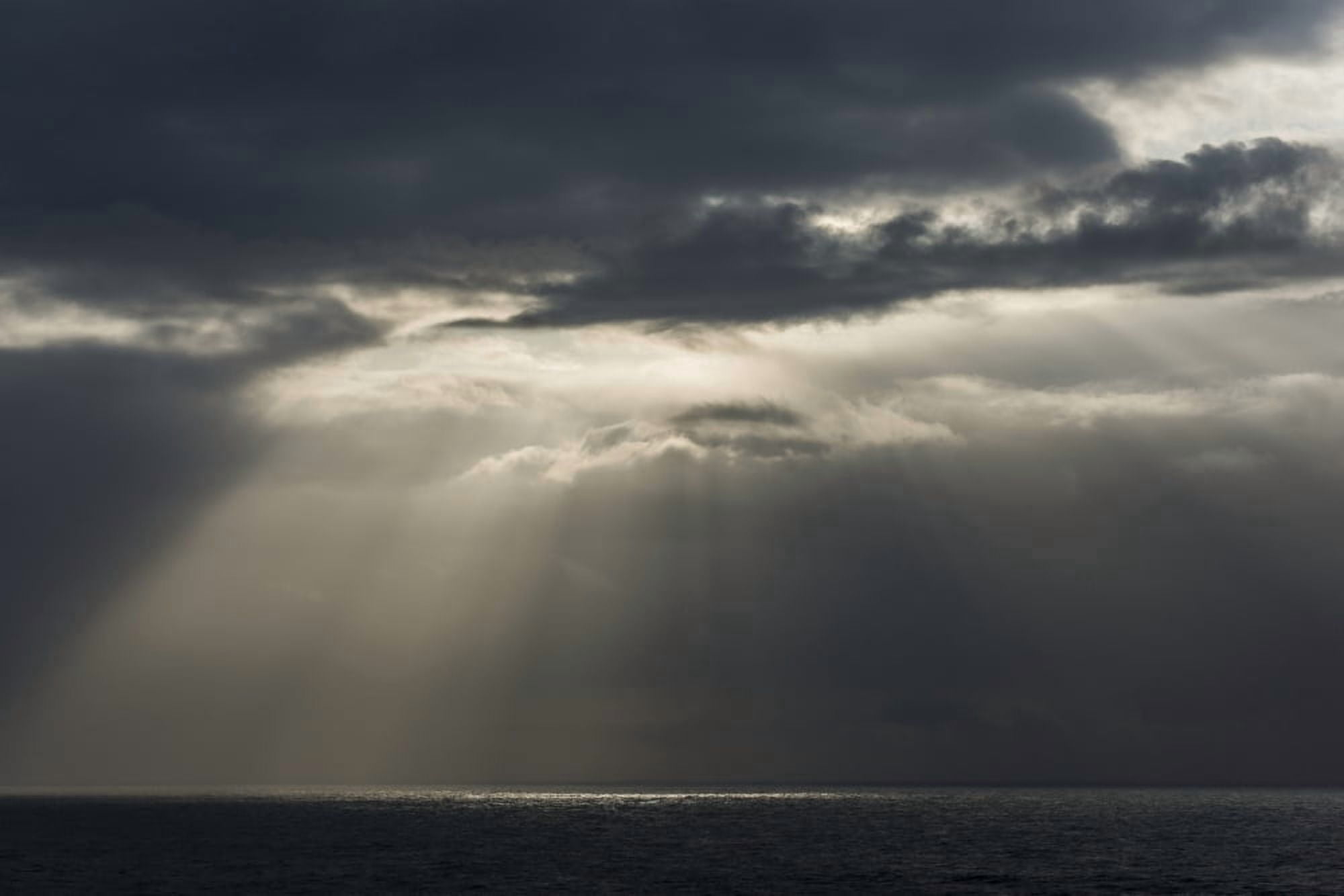 Sunlight breaks through the clouds over the ocean on the Oregon coast Cannon Beach Oregon United States of America Canvas Art - Robert L Potts Design Pics (18 x 12)