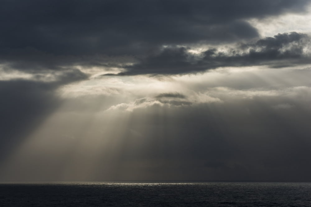 Sunlight breaks through the clouds over the ocean on the Oregon coast Cannon Beach Oregon United States of America Canvas Art - Robert L Potts Design Pics (36 x 24)